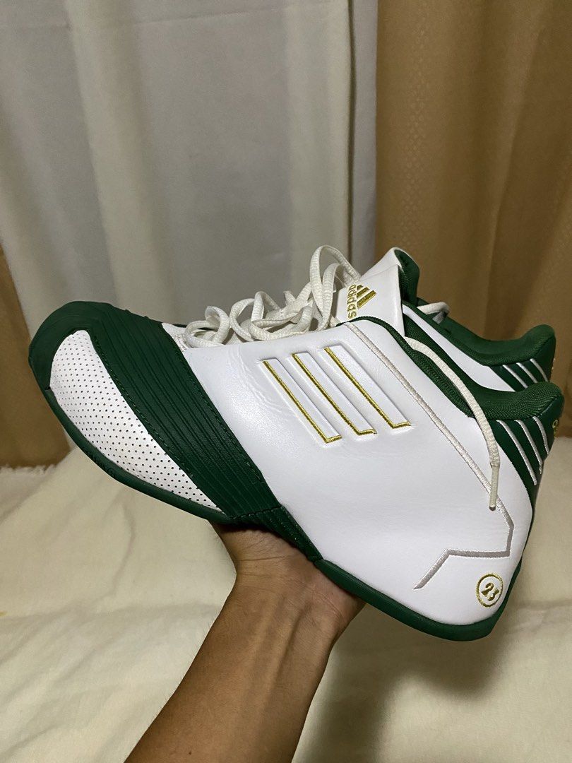 Adidas T-Mac 1" x lebron james (Category: Sneakers) located in Barobo. Submitted by sonogonggr22560 (Listing ID 1448030440, Image 1). Description: - Adidas T-Mac 3 basketball shoes - Color: White with green and gold accents - Iconic three stripes design - '23' detail on the heel - Perfect for collectors or players.