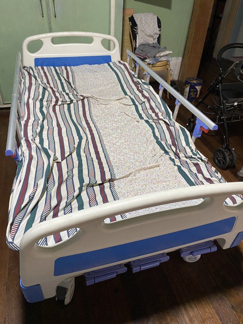 Adjustable Hospital Bed with Side Rails and Wheels (Category: Medical Supplies & Tools) located in Manila. Submitted by tavorafrancis8096 (Listing ID 1447907081, Image 1). Description: - Hospital bed for sale - Adjustable side rails - Wheels for easy movement - White and blue bed frame - Includes mattress and bedding - Perfect for home care needs.