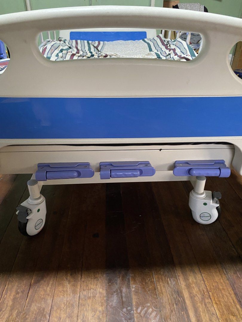 Adjustable Hospital Bed with Side Rails and Wheels (Category: Medical Supplies & Tools) located in Manila. Submitted by tavorafrancis8096 (Listing ID 1447907081, Image 2). Description: - Hospital bed for sale - Adjustable side rails - Wheels for easy movement - White and blue bed frame - Includes mattress and bedding - Perfect for home care needs.