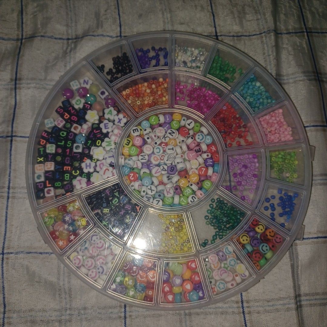 Assorted Craft Beads for Jewelry Making (Category: Craft Supplies & Tools) located in Quezon City. Submitted by ukaykingdom (Listing ID 1447935628, Image 3). Description: Assorted beads - Round plastic container filled with assorted craft beads. - Includes alphabet beads, smiley face beads, and flower beads. - Also contains a variety of colorful small beads. - Ideal for creating DIY bracelets, necklaces, and other jewelry. - Offers a great variet