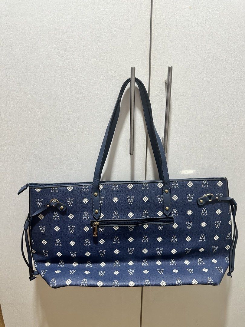 AYLA BAG Navy Monogram Tote Bag (Category: Tote Bags) located in Antipolo. Submitted by soshops (Listing ID 1448019412, Image 2). Description: - can fit A LOT - never used (naka stock lang) - Side string details for adjustable width Measurements: - Length: 19 inch - Height: 11.5 inch - All-over Ayla monogram pattern - Gold hardware details - Spacious interior with zippered compartment - Top zipper closure - Comfortable shoulder straps.
