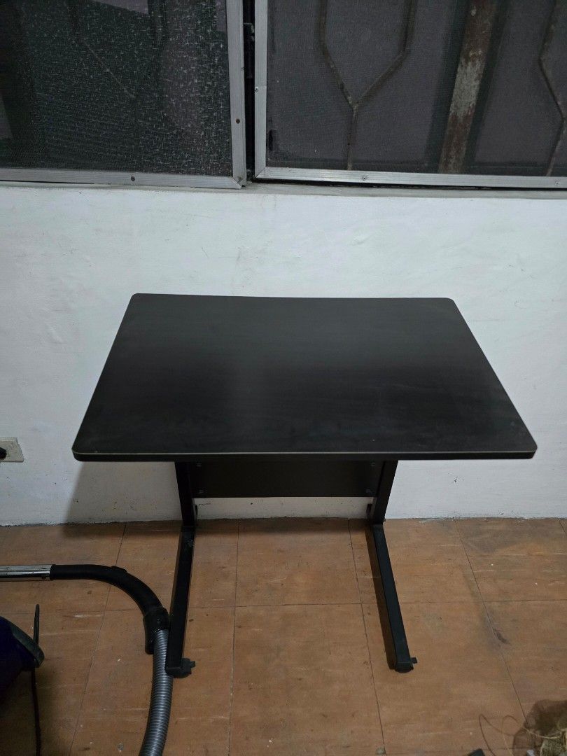 Black Adjustable Laptop Table (Category: Tables & Sets) located in Makati City. Submitted by shopaholicsgallery (Listing ID 1448004136, Image 3). Description: - Black adjustable laptop table - Sturdy metal frame and legs - Ideal for small spaces - Easy to install - Versatile: use as a desk or extra counter space.