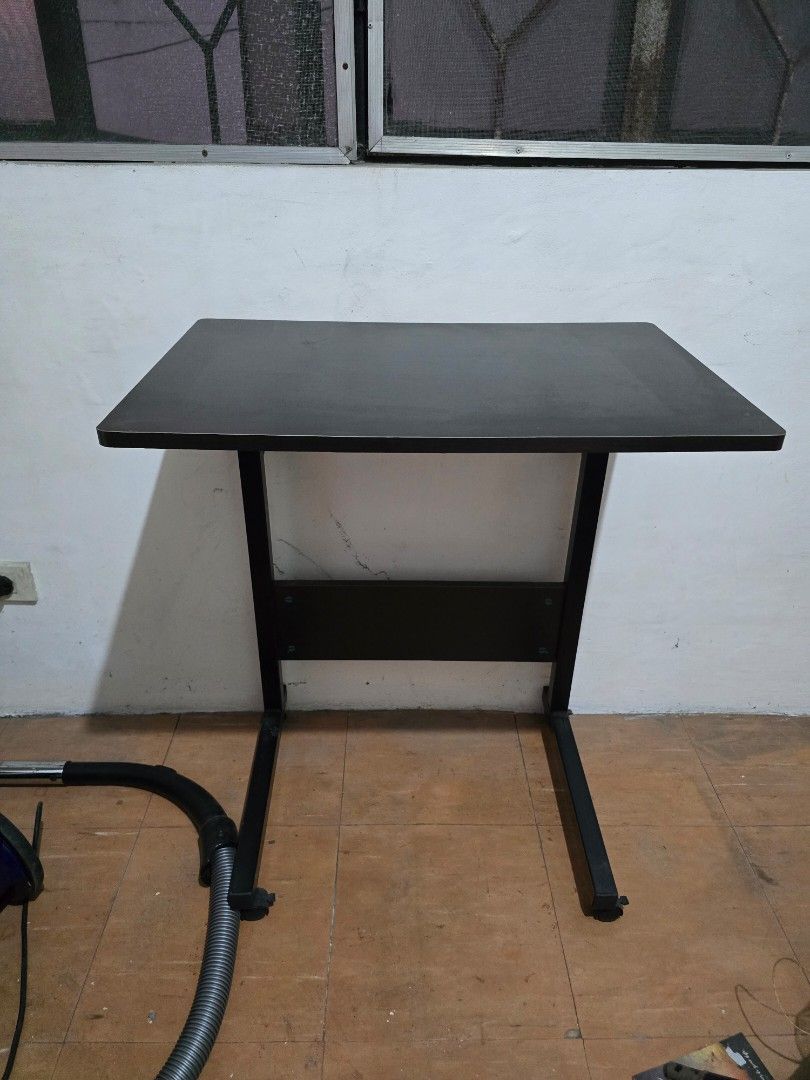 Black Adjustable Laptop Table (Category: Tables & Sets) located in Makati City. Submitted by shopaholicsgallery (Listing ID 1448004136, Image 1). Description: - Black adjustable laptop table - Sturdy metal frame and legs - Ideal for small spaces - Easy to install - Versatile: use as a desk or extra counter space.