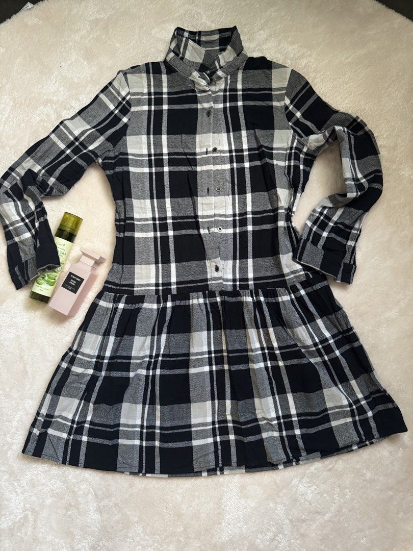 Black and White Plaid Button-Up Tiered Dress (Category: Dresses) located in Dasmarinas. Submitted by Seri_Mae (Listing ID 1447964049, Image 1). Description: - Adorable black and white plaid design - Long sleeves with button cuffs - Chic high neckline with button closure - Flowy tiered skirt for a flattering silhouette - Versatile for casual outings or as a layering piece - Effortlessly style with boots or sneakers.
