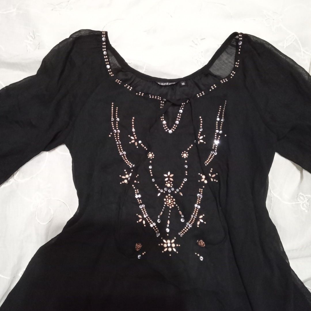Black Sheer Blouse with Embellishments (Category: Blouses) located in Talisay. Submitted by peonisces (Listing ID 1448009943, Image 3). Description: size small to semi med flaw some embellishments missing - Sheer black fabric - Long sleeves - Intricate bead and sequin embellishments on the front - Scoop neck with tie detail - Lightweight and flowy material - Versatile for layering or dressing up - Pairs well with jeans or skirts.
