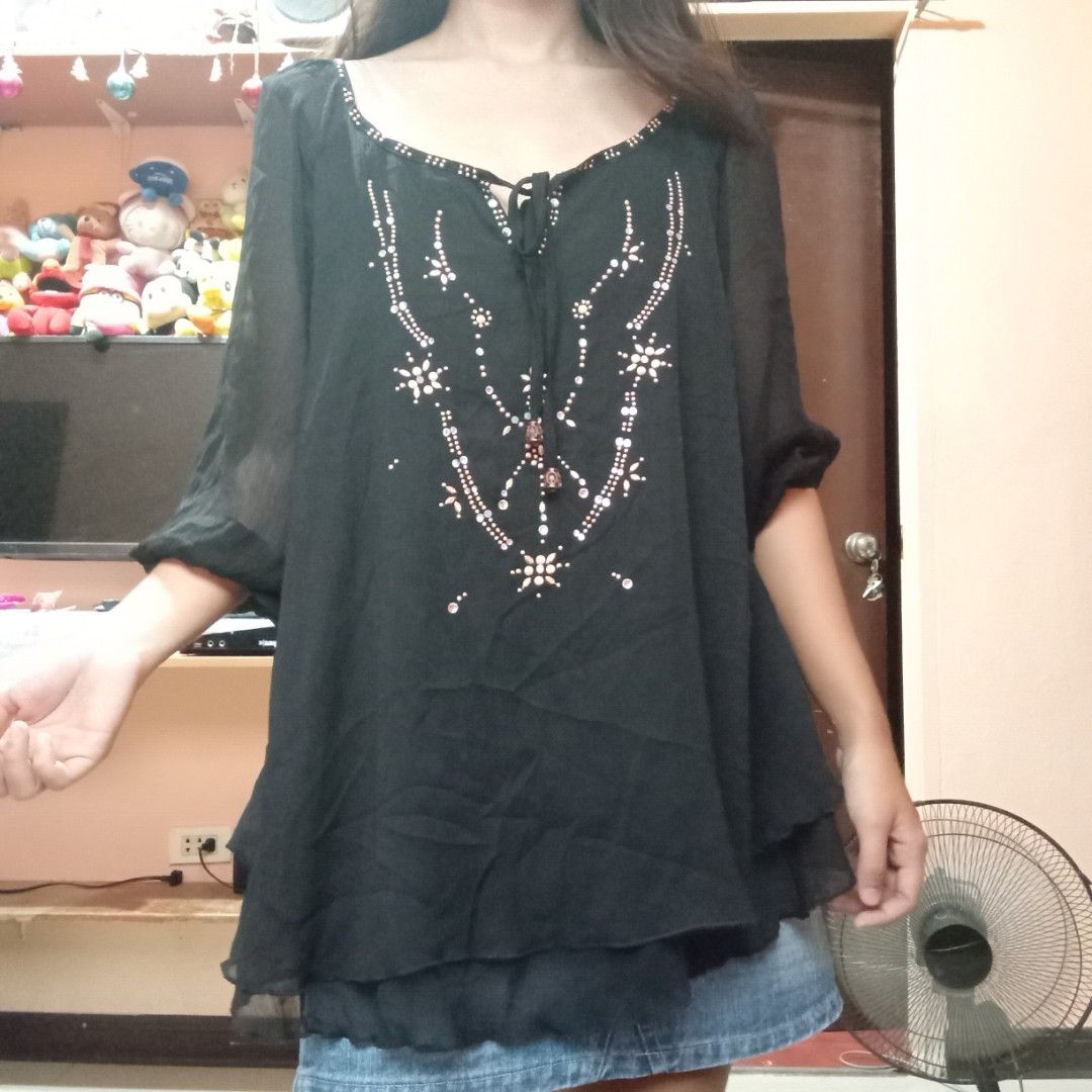 Black Sheer Blouse with Embellishments (Category: Blouses) located in Talisay. Submitted by peonisces (Listing ID 1448009943, Image 2). Description: size small to semi med flaw some embellishments missing - Sheer black fabric - Long sleeves - Intricate bead and sequin embellishments on the front - Scoop neck with tie detail - Lightweight and flowy material - Versatile for layering or dressing up - Pairs well with jeans or skirts.