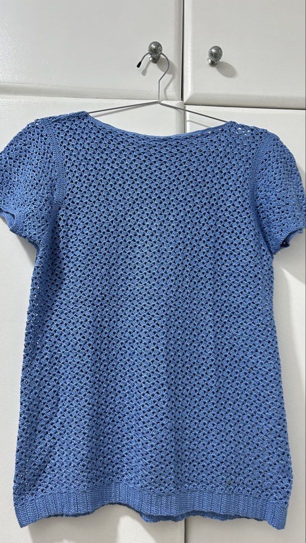 Blue Crochet Short Sleeve Top (Category: Blouses) located in San Fernando. Submitted by TheBTBs (Listing ID 1447948218, Image 1). Description: - Light blue crochet top - Short sleeves -handmade - Open knit pattern - Ribbed hem - Versatile: great for layering or wearing on its own - Approx. Measurements: 22 inches length, 18 inches chest width ⚠️ Reminder Color may appear slightly different in photos due to lighting and screen settings. No return 