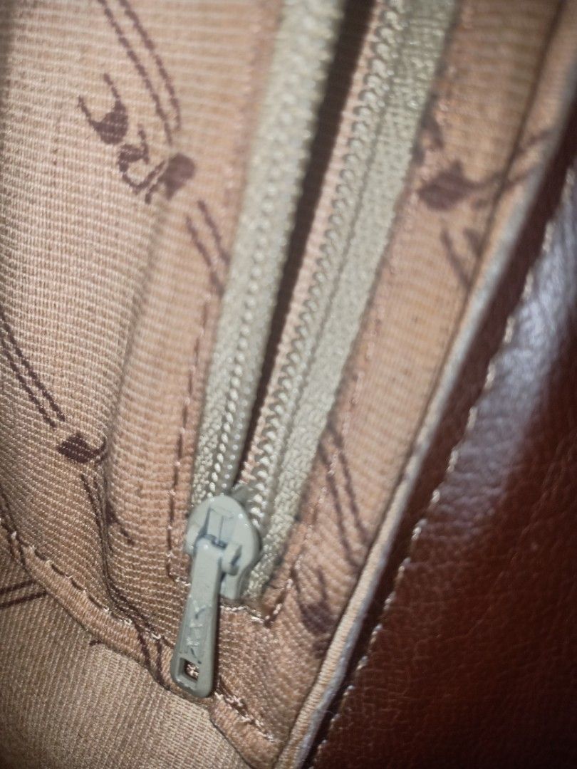 Brown Leather Crocodile Embossed Clutch Bag with Strap (Category: Clutches) located in Manila. Submitted by macchi1216 (Listing ID 1447976450, Image 3). Description: - Brown leather clutch - Crocodile embossed flap - Detachable strap with buckle - Zipper closure inside - Patterned lining - Ideal for evenings out or as a statement piece.