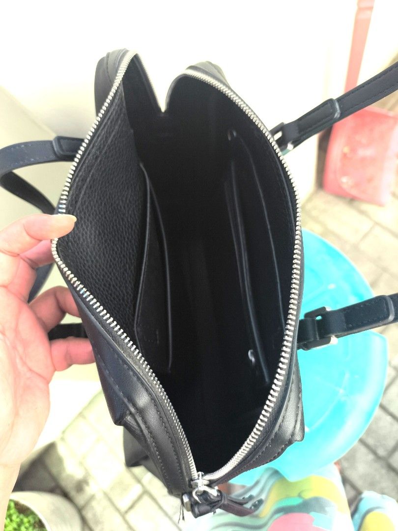 Calvin Klein Black Leather Satchel Handbag (Category: Luxury Bags & Wallets) located in Cavite. Submitted by Combiishop (Listing ID 1447888165, Image 2). Description: - Genuine textured leather in classic black - Versatile top handles and detachable shoulder strap - Secure zipper closure - Organized interior with multiple pockets - Timeless and simple design, ideal for daily use original po ito from munich germany 1month use lang negotiable.