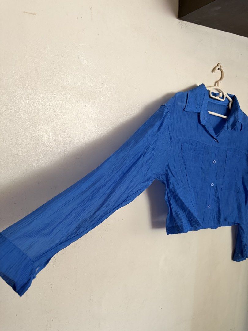 CHOEGO Blue Textured Cropped Button-Up Shirt (Category: Longsleeves) located in Angeles City. Submitted by endzn (Listing ID 1447934266, Image 3). Description: - Blue cropped shirt from CHOEGO - Textured fabric - Two chest pockets - Button-up front with collar - Long sleeves - Easy to style for casual or dressed-up looks.