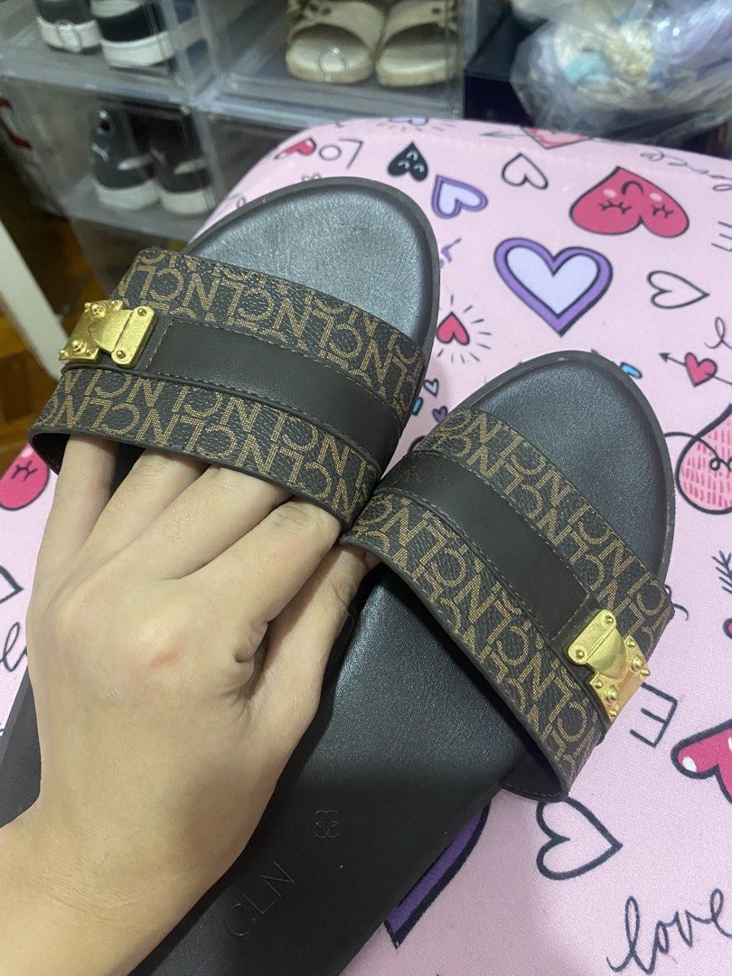 CLN Brown Monogram Slides with Gold Buckle (Category: Flats & Sandals) located in Taguig. Submitted by mumpreloveddd (Listing ID 1448065139, Image 2). Description: - Brand: CLN - Color: Brown - Design: Monogram pattern on strap - Detail: Gold buckle accent - Style: Slip-on - Occasion: Casual wear.