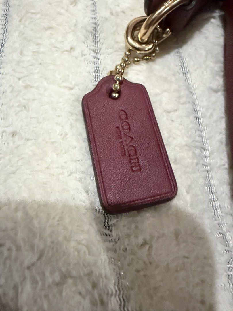 Coach Embossed Signature Leather Shoulder Bag (Category: Luxury Bags & Wallets) located in Mandaluyong City. Submitted by getbounced (Listing ID 1448073711, Image 3). Description: - Genuine red leather Coach shoulder bag - Signature Coach embossing - Elegant gold chain strap and leather handle - Secure zipped closure - Includes original Coach dust bag and authenticity card - Versatile for evening events or daily wear.