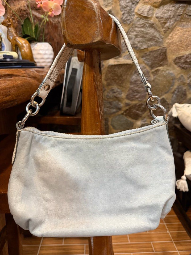 Coach Light Blue Leather Shoulder Bag (Category: Luxury Bags & Wallets) located in Davao. Submitted by ishuh (Listing ID 1447968744, Image 2). Description: - Light blue Coach shoulder bag - Genuine leather with white trim - Silver hardware and chain details - Secure top zipper closure - Interior features a vibrant purple lining.