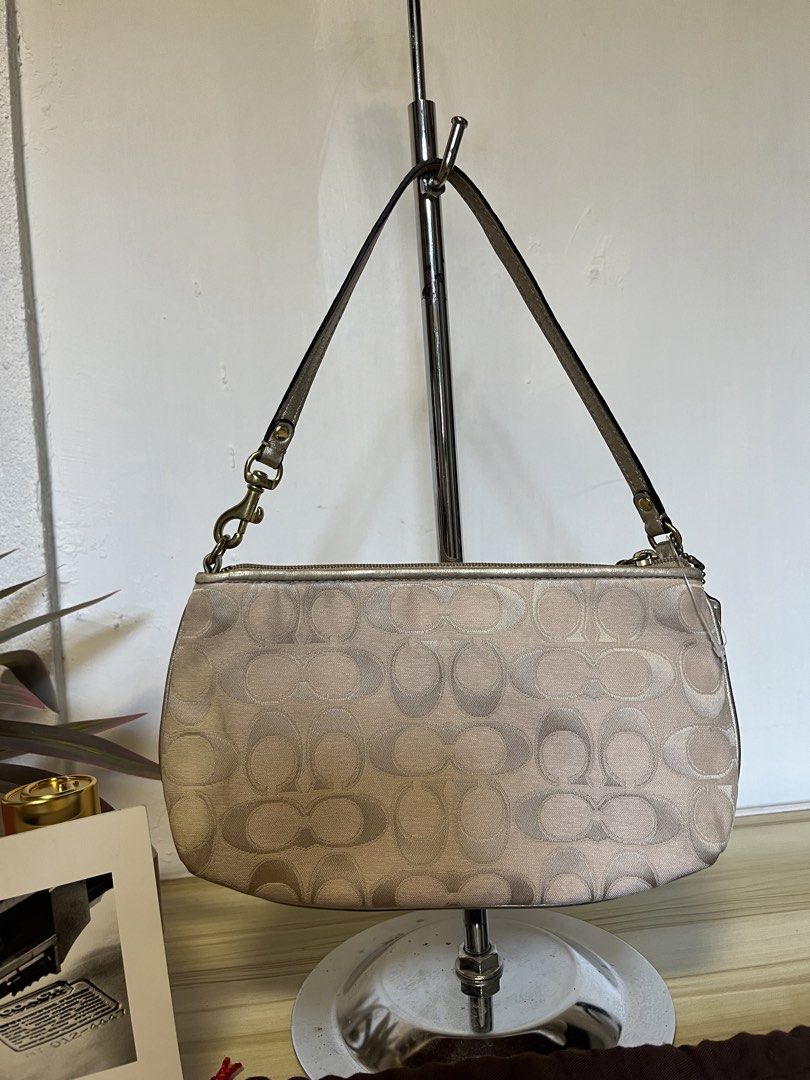 Coach Madison Pink Monogram Shoulder Bag (Category: Luxury Bags & Wallets) located in Quezon. Submitted by consulhann69386 (Listing ID 1447921854, Image 2). Description: - Light pink Coach shoulder bag - Signature monogram pattern - Metallic silver accent with Coach logo on front - Multiple interior pockets - Made in the Philippines - Comes with original Coach dust bag.