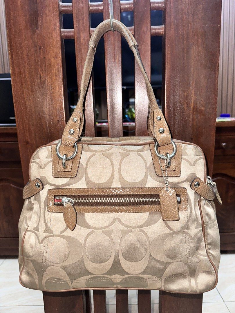 Coach Monogram Canvas & Leather Trim Shoulder Bag (Category: Luxury Bags & Wallets) located in Manila. Submitted by declutterw1thme (Listing ID 1448057252, Image 2). Description: - Authentic Coach shoulder bag in signature monogram canvas. - Tan leather trim and handles. - Convenient front zip pocket. - Spacious interior lined with coral pink satin. - Shows some signs of wear on handles and leather trim, adding character to this classic piece..