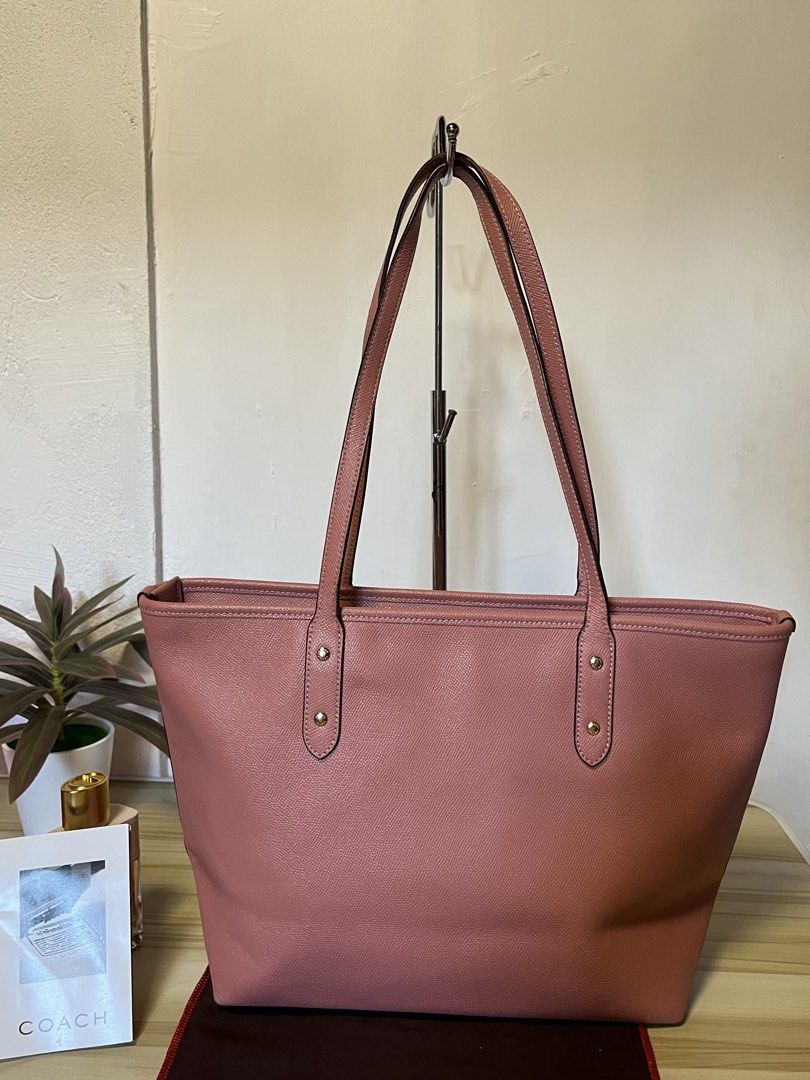 Coach Pink Leather Tote Bag (Category: Luxury Bags & Wallets) located in Quezon. Submitted by consulhann69386 (Listing ID 1447922645, Image 3). Description: - Authentic Coach tote bag - Lovely pink shade - Textured leather exterior - Double shoulder straps - Spacious interior, ideal for essentials - Perfect for everyday use or travel.