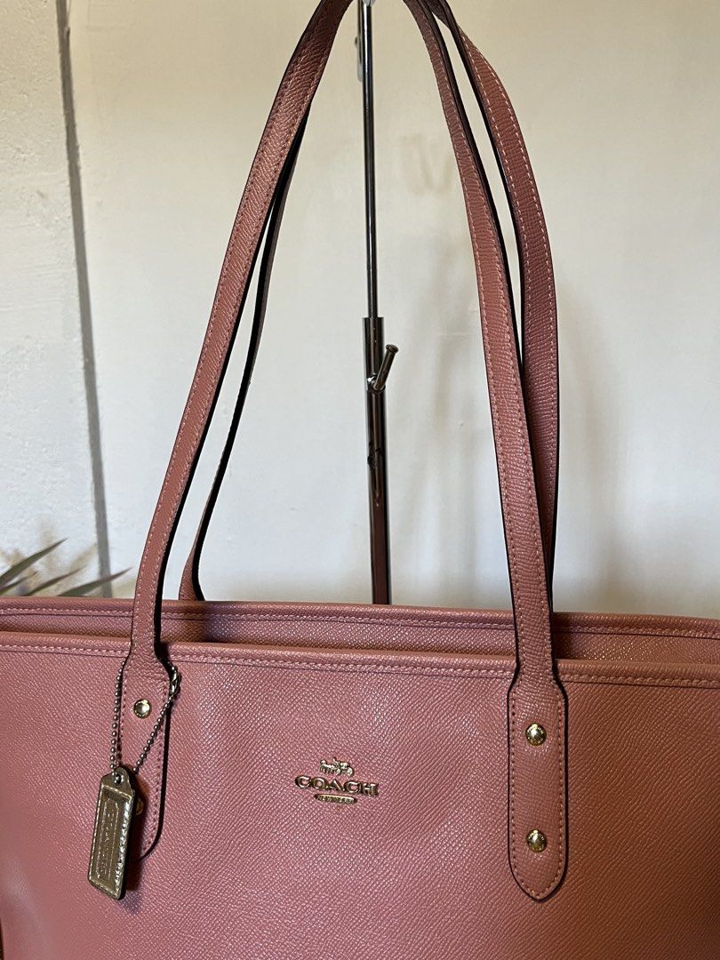 Coach Pink Leather Tote Bag (Category: Luxury Bags & Wallets) located in Quezon. Submitted by consulhann69386 (Listing ID 1447922645, Image 2). Description: - Authentic Coach tote bag - Lovely pink shade - Textured leather exterior - Double shoulder straps - Spacious interior, ideal for essentials - Perfect for everyday use or travel.