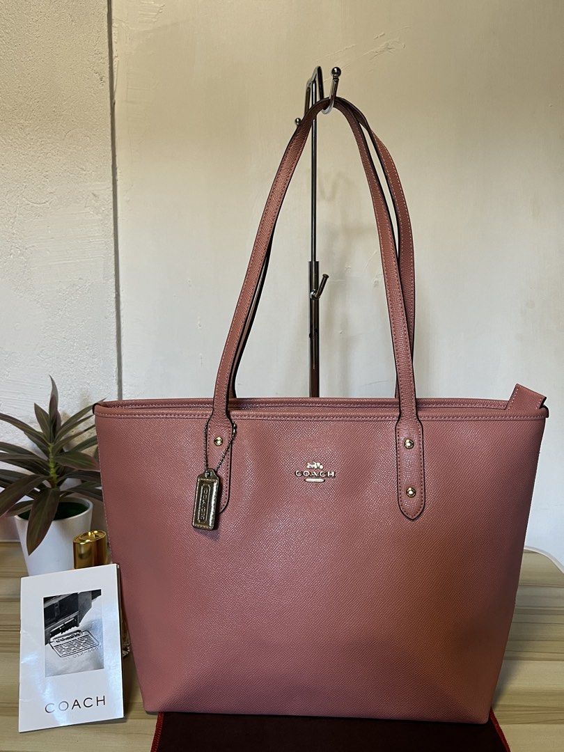 Coach Pink Leather Tote Bag (Category: Luxury Bags & Wallets) located in Quezon. Submitted by consulhann69386 (Listing ID 1447922645, Image 1). Description: - Authentic Coach tote bag - Lovely pink shade - Textured leather exterior - Double shoulder straps - Spacious interior, ideal for essentials - Perfect for everyday use or travel.
