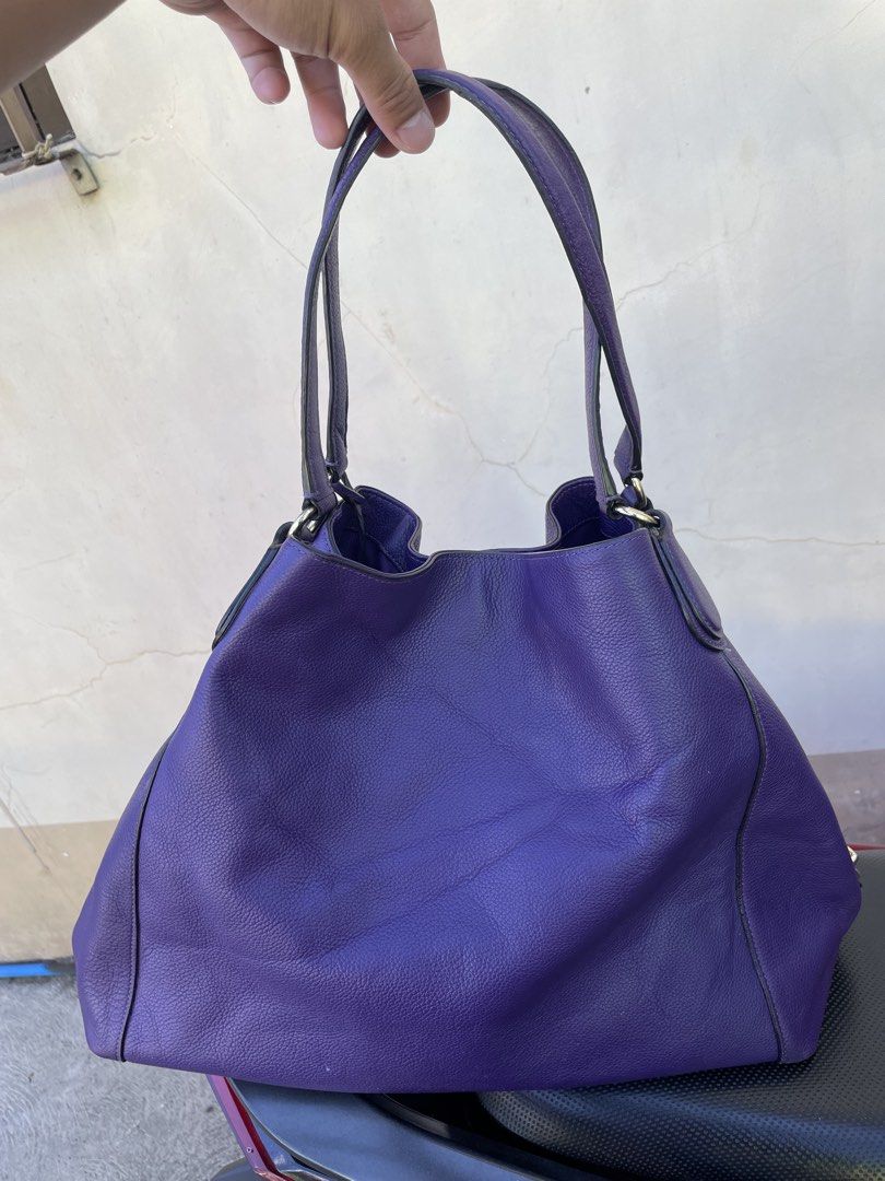 Coach Purple Leather Hobo Shoulder Bag (Category: Luxury Bags & Wallets) located in Siniloan. Submitted by rethr1ft (Listing ID 1447955765, Image 2). Description: - Authentic purple leather Coach hobo bag - Elegant embossed horse and carriage detail on the front - Stylish gold-tone hardware - Spacious interior with multiple compartments - Includes a secure zip pocket inside - Interior is clean and well-maintained - Ideal for everyday use and vers