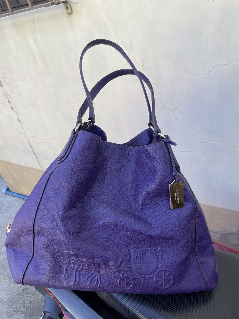 Coach Purple Leather Hobo Shoulder Bag (Category: Luxury Bags & Wallets) located in Siniloan. Submitted by rethr1ft (Listing ID 1447955765, Image 1). Description: - Authentic purple leather Coach hobo bag - Elegant embossed horse and carriage detail on the front - Stylish gold-tone hardware - Spacious interior with multiple compartments - Includes a secure zip pocket inside - Interior is clean and well-maintained - Ideal for everyday use and vers