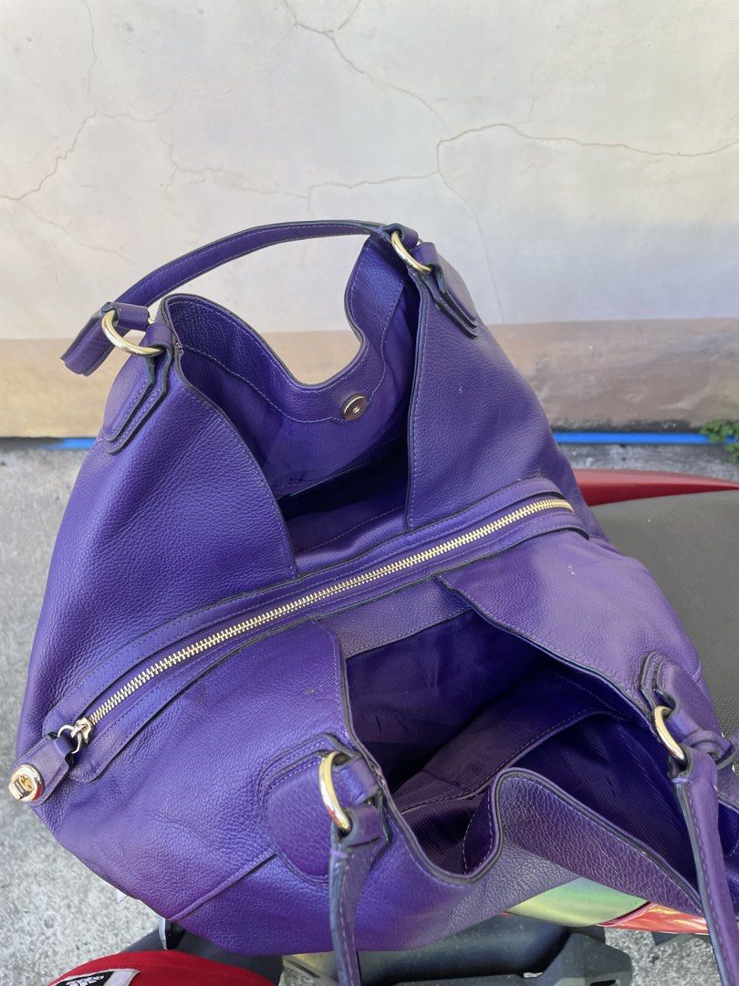 Coach Purple Leather Hobo Shoulder Bag (Category: Luxury Bags & Wallets) located in Siniloan. Submitted by rethr1ft (Listing ID 1447955765, Image 3). Description: - Authentic purple leather Coach hobo bag - Elegant embossed horse and carriage detail on the front - Stylish gold-tone hardware - Spacious interior with multiple compartments - Includes a secure zip pocket inside - Interior is clean and well-maintained - Ideal for everyday use and vers