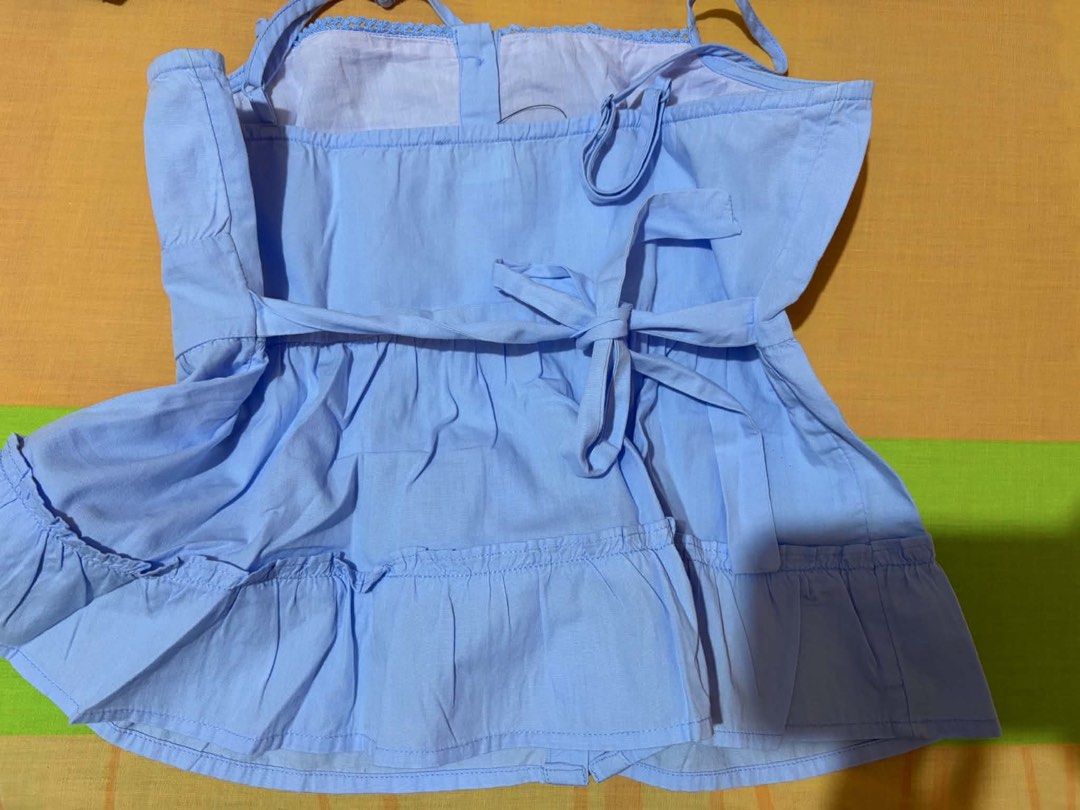 Cotton On Blue Tiered Button Front Cami Top (Category: Sleeveless) located in Cabuyao City. Submitted by declutter_w_mee (Listing ID 1447964290, Image 3). Description: - Cute blue cami top from Cotton On - Tiered design with button front detail - Adjustable spaghetti straps - Tie at the back - Ruffle hem - Versatile for casual or dressed-up looks.