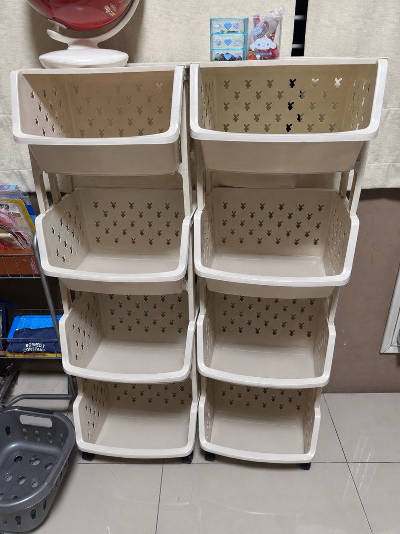 Cream 8 Tier Storage Rack with Bunny Cutouts (Category: Storage Boxes & Baskets) located in Quezon City. Submitted by flowercharm (Listing ID 1448002231, Image 2). Description: - Cream colored 8-tier storage rack - 4 tiers on each side - Adorable bunny cutouts on each tier - Versatile for toys, toiletries, or kitchen organization - Equipped with wheels for easy mobility - Space-saving design, perfect for small areas.