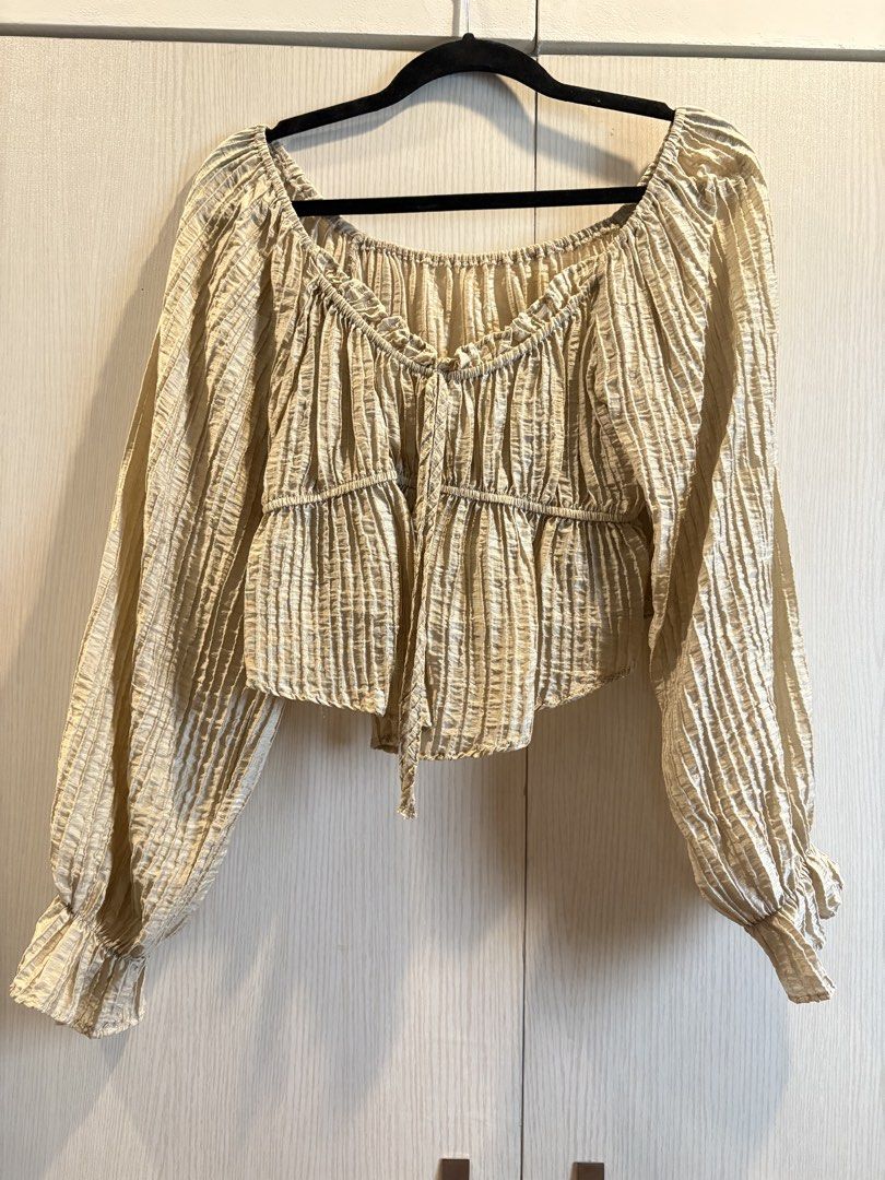 Crinkle Textured Off-Shoulder Long Sleeve Top (Category: Longsleeves) located in Quezon City. Submitted by mikamdr (Listing ID 1447979600, Image 1). Description: - Crinkle textured fabric for a unique look. - Flattering off-shoulder neckline. - Stylish tie-front detail. - Billowy long sleeves with elasticated cuffs. - Versatile piece, pairs well with high-waisted bottoms..