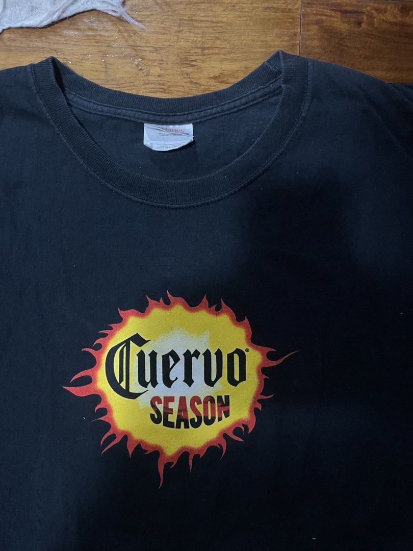 Cuervo Season '06 T-Shirt (Category: Tshirts & Polo Shirts ) located in Cainta. Submitted by FirstBuys (Listing ID 1447995749, Image 2). Description: 23 x 30 - Black t-shirt with 'Cuervo Season' graphic on the front. - Back design: 'VIVE Cuervo' and 'SHOT POURED 'ROUND THE WORLD '06'. - Ideal for fans of the brand. - Great for everyday casual wear..
