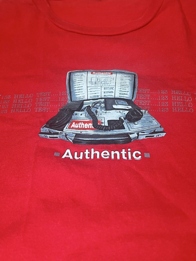 DNS Red T-shirt with Authentic Graphic Print (Category: Tshirts & Polo Shirts ) located in Naga. Submitted by retro_rackph (Listing ID 1448027470, Image 2). Description: - Brand: DNS - Color: Red - Size: L - Design: Graphic print with 'Authentic' text and retro computer/phone graphic - Background detail: Repeated '123 TEST...' text - Ideal for: Casual wear 21x26.
