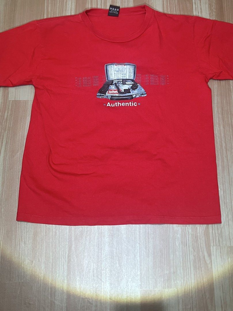 DNS Red T-shirt with Authentic Graphic Print (Category: Tshirts & Polo Shirts ) located in Naga. Submitted by retro_rackph (Listing ID 1448027470, Image 1). Description: - Brand: DNS - Color: Red - Size: L - Design: Graphic print with 'Authentic' text and retro computer/phone graphic - Background detail: Repeated '123 TEST...' text - Ideal for: Casual wear 21x26.