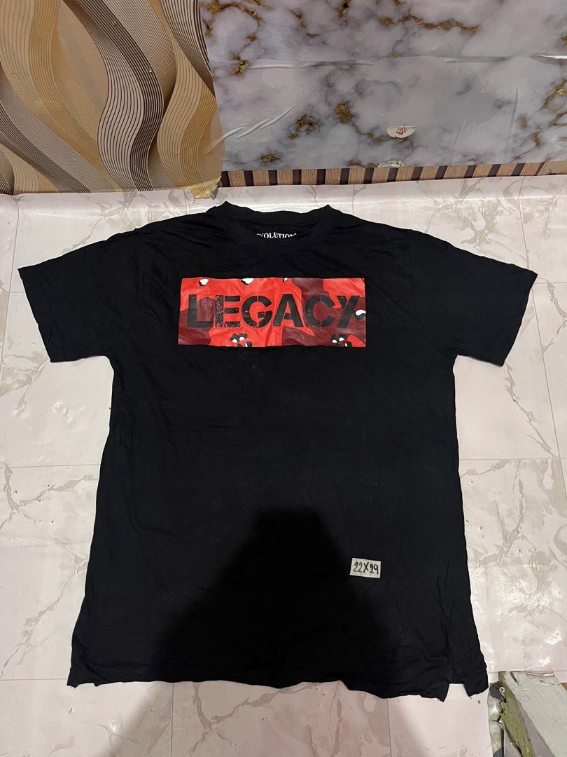 Evolution In Design Black Legacy T-Shirt XL (Category: Tshirts & Polo Shirts ) located in Manila. Submitted by avelinorj.391 (Listing ID 1447936476, Image 1). Description: - Brand: Evolution In Design - Color: Black - Size: XL - Design: Red camouflage 'LEGACY' graphic on front - Material: 100% Cotton - Style: Casual wear - Condition: Please check photos for details.