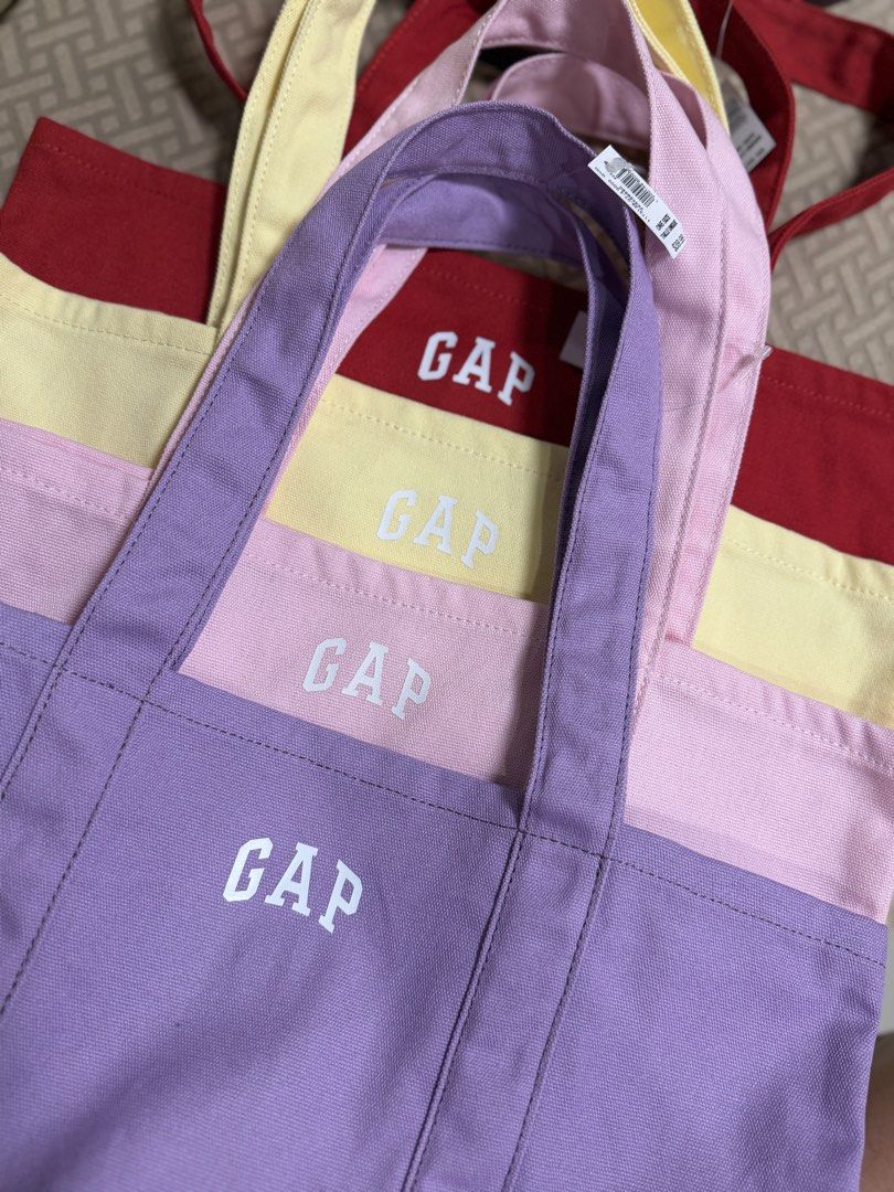 GAP Canvas Tote Bag - Multiple Colors Available (Category: Tote Bags) located in Mandaluyong City. Submitted by treasureeverythingph (Listing ID 1448001048, Image 2). Description: - Cute GAP canvas tote bags - Availablee colors: Red, Yellow, Pink, Purple - Perfect for everyday use, books, or groceries - Durable material - Includes inner pockets Mandaluyong .