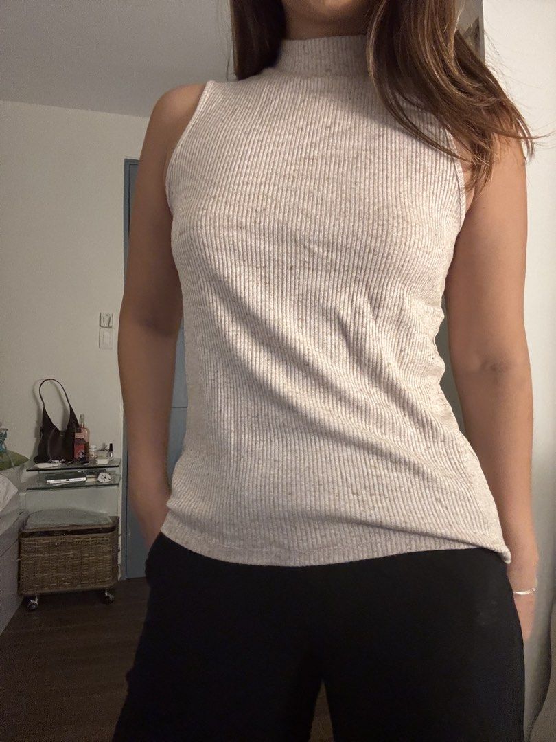 GAP Ribbed Mock Neck Sleeveless Top (Category: Sleeveless) located in Las Pinas. Submitted by fl0under_ (Listing ID 1447928271, Image 1). Description: - Sleeveless top with a chic mock neck - All-over ribbed texture for a stylish look - Versatile beige color with subtle darker speckles - Fitted silhouette that flatters your figure - Ideal for layering or as a standalone piece - Effortlessly pairs with any outfit.