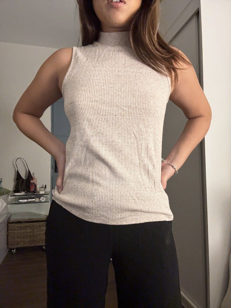 GAP Ribbed Mock Neck Sleeveless Top (Category: Sleeveless) located in Las Pinas. Submitted by fl0under_ (Listing ID 1447928271, Image 2). Description: - Sleeveless top with a chic mock neck - All-over ribbed texture for a stylish look - Versatile beige color with subtle darker speckles - Fitted silhouette that flatters your figure - Ideal for layering or as a standalone piece - Effortlessly pairs with any outfit.