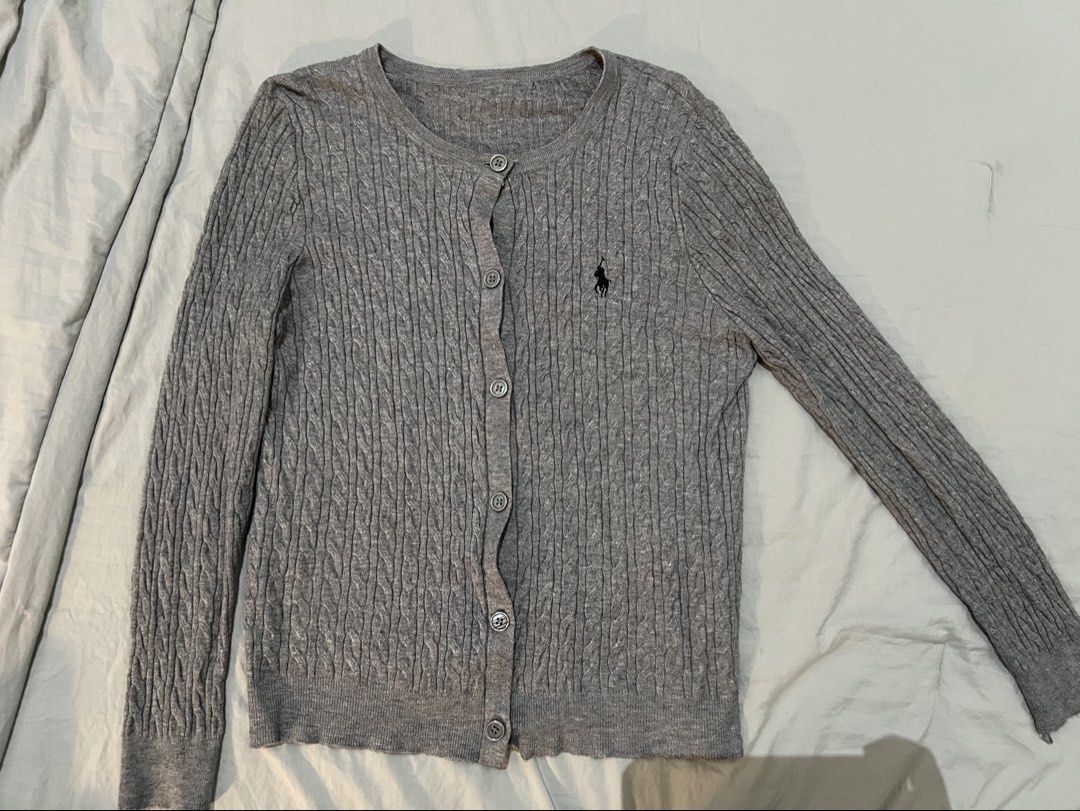 Grey Cable Knit Cardigan (Category: Coats, Jackets and Outerwear) located in Kuala Lumpur. Submitted by yaurossie (Listing ID 1447988046, Image 1). Description: PRE-LOVED ITEMS! - Classic grey Ralph Lauren (non-ori) cable knit cardigan - Long sleeves - Button-up front - Signature pony logo embroidered on chest - Perfect for layering - Soft and comfortable material.