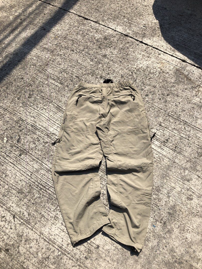 Hiking pants (Category: Activewear) located in Caloocan City. Submitted by thriftniotep. (Listing ID 1448015319, Image 2). Description: - Khaki hiking pants - Zip-off legs convert to shorts - Elastic waistband with drawstring and buckle - Multiple zippered pockets (front and back) - Adjustable toggles at the ankles - Ideal for outdoor adventures.