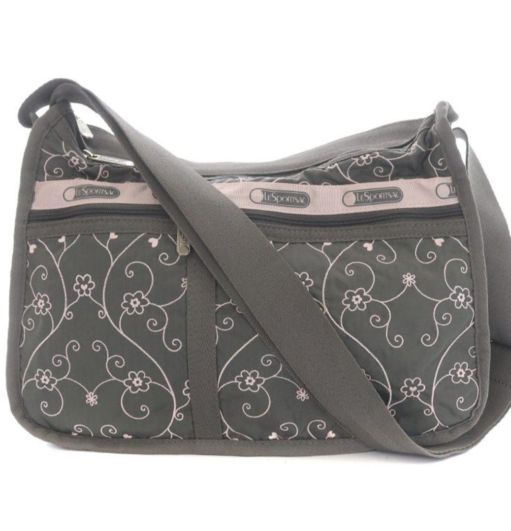 LeSportsac Deluxe Everyday Bag (Category: Shoulder Bags) located in Muntinlupa City. Submitted by kmrod (Listing ID 1447985399, Image 1). Description: - Stylish gray and pink LeSportsac shoulder bag - Features a pretty pink floral vine embroidered pattern - Adjustable strap with buckle for customized fit - Multiple zippered pockets on the front for secure storage - Ideal size for everyday use and carrying essentials Approximate Dimensions: Height