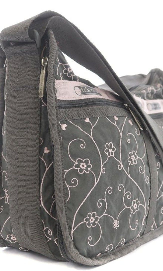 LeSportsac Deluxe Everyday Bag (Category: Shoulder Bags) located in Muntinlupa City. Submitted by kmrod (Listing ID 1447985399, Image 3). Description: - Stylish gray and pink LeSportsac shoulder bag - Features a pretty pink floral vine embroidered pattern - Adjustable strap with buckle for customized fit - Multiple zippered pockets on the front for secure storage - Ideal size for everyday use and carrying essentials Approximate Dimensions: Height
