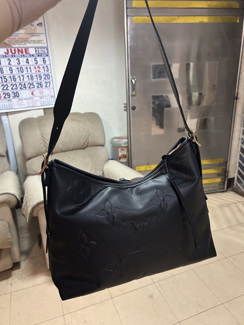 Louis Vuitton Black Monogram Embossed Hobo Bag (Category: Luxury Bags & Wallets) located in Quezon City. Submitted by rottiemom (Listing ID 1448026666, Image 2). Description: - Louis Vuitton black hobo bag - Textured monogram pattern all over - Elegant gold hardware details - Adjustable strap for comfort - Includes a small leather tag - Ideal everyday bag.