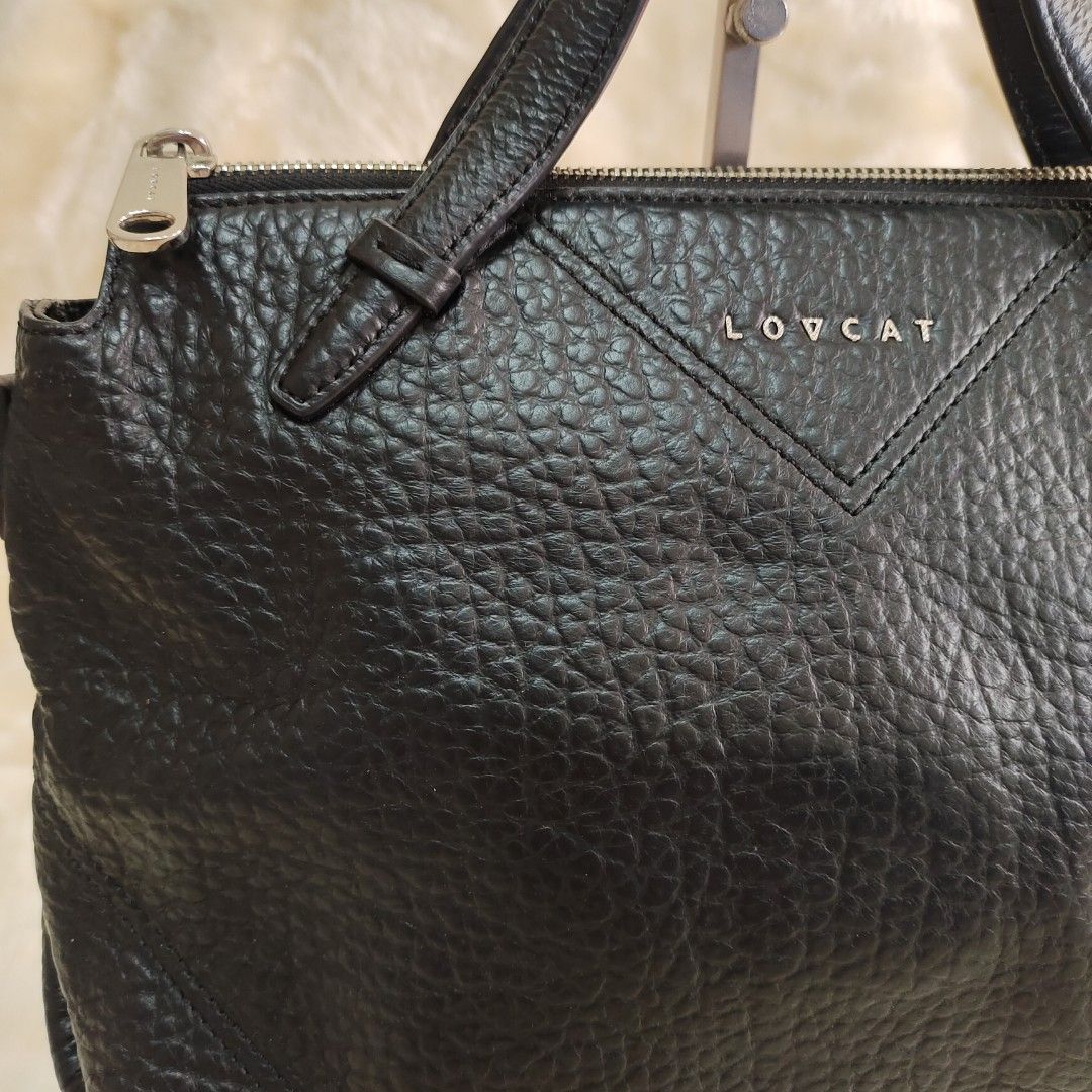 LOVCAT Black Leather Handbag with Sling Strap (Category: Shoulder Bags) located in Binan City. Submitted by apparelsbyeve (Listing ID 1447957292, Image 2). Description: PRELOVED: - Brand: LOVCAT - Color: Black - Material: Textured Leather - Closure: Zipper - Straps: Top handles and detachable sling strap - Size Reference: iPhone 15 Pro included in photos.