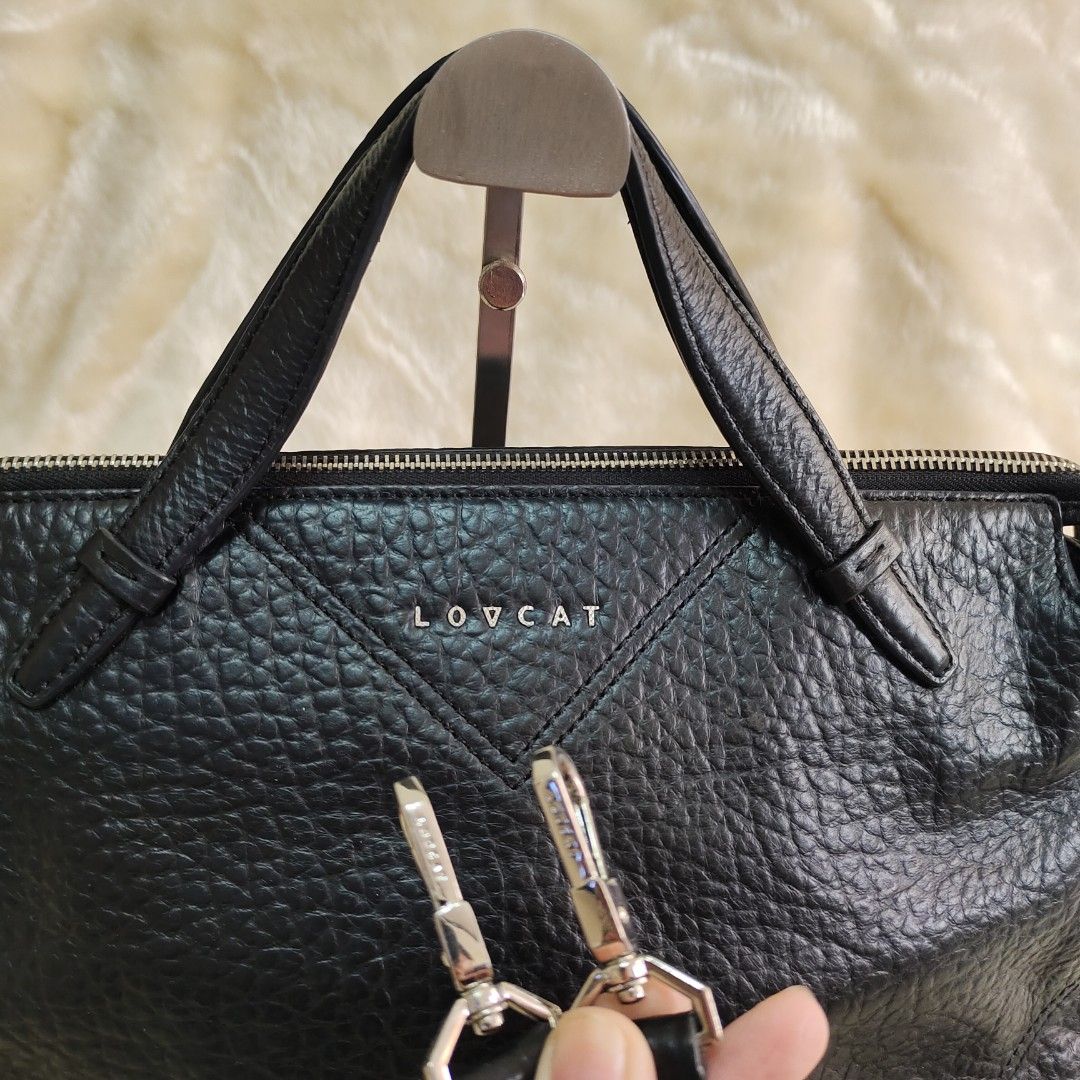 LOVCAT Black Leather Handbag with Sling Strap (Category: Shoulder Bags) located in Binan City. Submitted by apparelsbyeve (Listing ID 1447957292, Image 3). Description: PRELOVED: - Brand: LOVCAT - Color: Black - Material: Textured Leather - Closure: Zipper - Straps: Top handles and detachable sling strap - Size Reference: iPhone 15 Pro included in photos.
