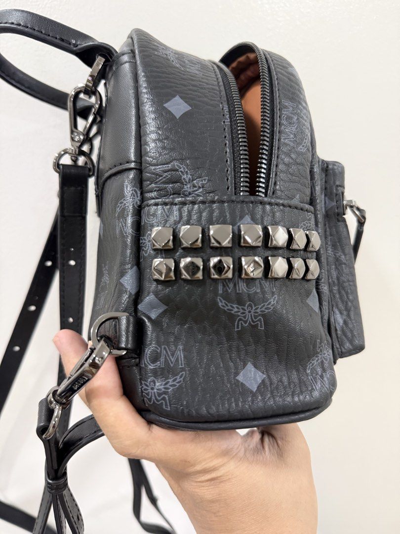 MCM Studded Mini Backpack Black Monogram (Category: Backpacks) located in San Juan City. Submitted by itskcborja002 (Listing ID 1447993663, Image 2). Description: - Authentic MCM mini backpack in black. - Features the signature MCM monogram print. - Stylish studded detail on the front pocket. - Genuine leather trim and adjustable straps. - Secure zipper closure for your belongings. - Includes a convenient interior pocket. - Ideal for everyday use