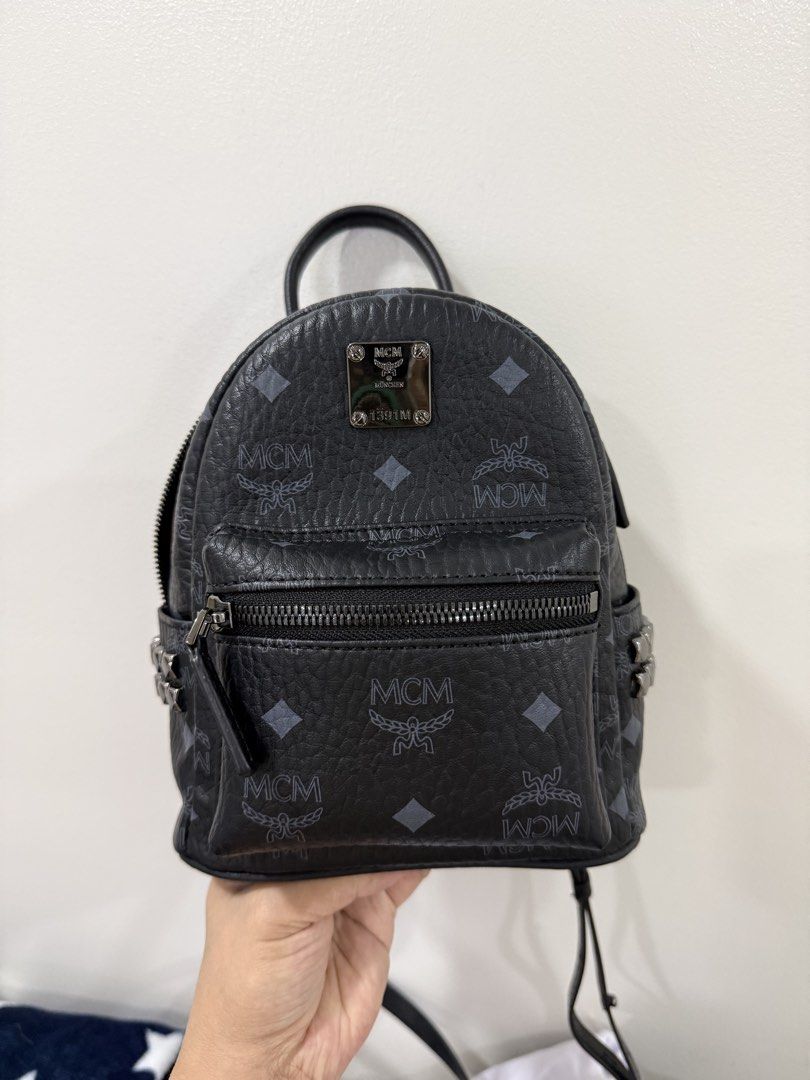 MCM Studded Mini Backpack Black Monogram (Category: Backpacks) located in San Juan City. Submitted by itskcborja002 (Listing ID 1447993663, Image 1). Description: - Authentic MCM mini backpack in black. - Features the signature MCM monogram print. - Stylish studded detail on the front pocket. - Genuine leather trim and adjustable straps. - Secure zipper closure for your belongings. - Includes a convenient interior pocket. - Ideal for everyday use