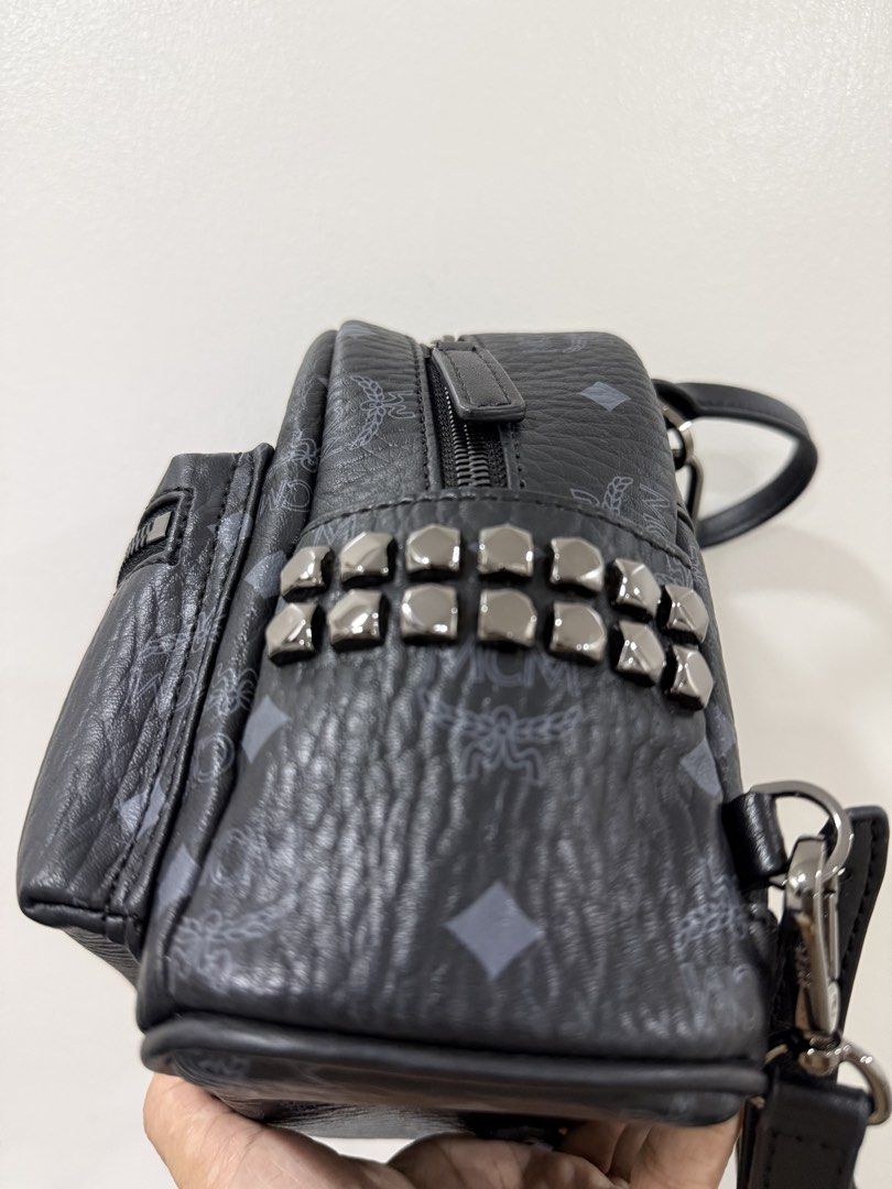 MCM Studded Mini Backpack Black Monogram (Category: Backpacks) located in San Juan City. Submitted by itskcborja002 (Listing ID 1447993663, Image 3). Description: - Authentic MCM mini backpack in black. - Features the signature MCM monogram print. - Stylish studded detail on the front pocket. - Genuine leather trim and adjustable straps. - Secure zipper closure for your belongings. - Includes a convenient interior pocket. - Ideal for everyday use