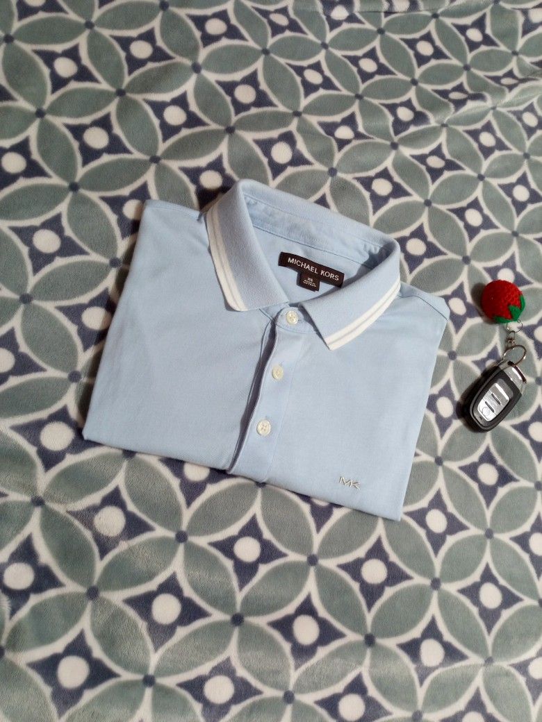Michael Kors Light Blue Polo Shirt (Category: Tshirts & Polo Shirts ) located in Cateel. Submitted by neoo_c (Listing ID 1447957178, Image 1). Description: - In Good Condition -MK on the chest -Dimensions: Width 18 Length 28.