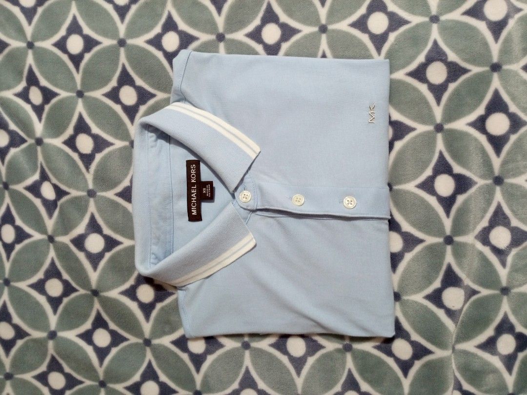 Michael Kors Light Blue Polo Shirt (Category: Tshirts & Polo Shirts ) located in Cateel. Submitted by neoo_c (Listing ID 1447957178, Image 2). Description: - In Good Condition -MK on the chest -Dimensions: Width 18 Length 28.