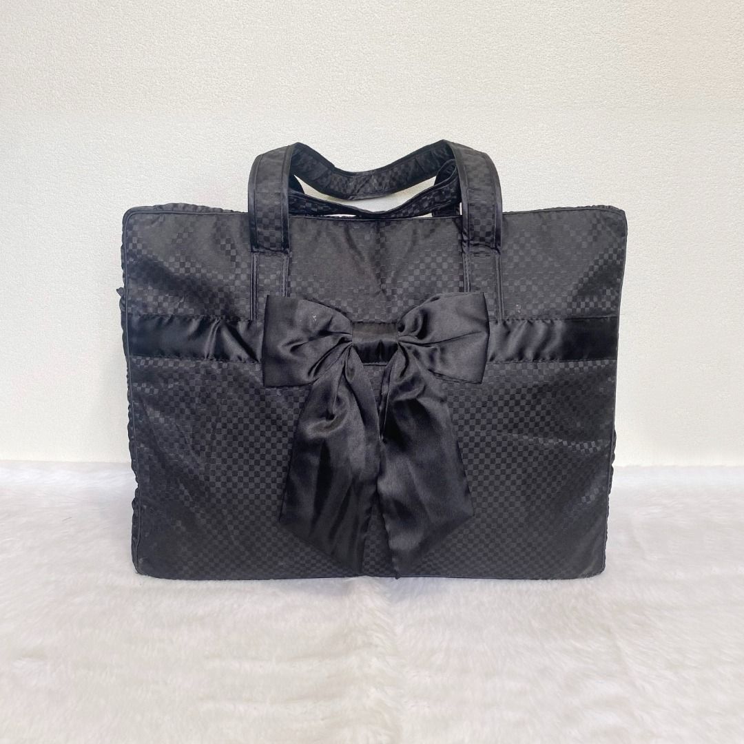 NaRaYa Black Quilted Large Weekender Bow Tote Bag (Category: Tote Bags) located in Cebu City. Submitted by posh_avenue888 (Listing ID 1448050765, Image 1). Description: In very good condition. From Japan. Crafted in satin-like fabric material. 100% authentic!!! 18.5" x 14" x 5.5". .