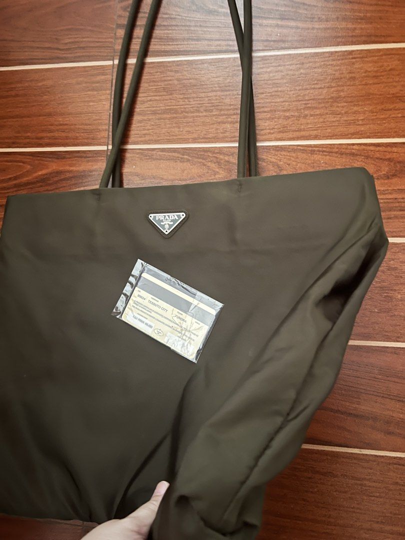 Original Prada Tessuto City Tote Bag (Category: Luxury Accessories) located in Lipa City. Submitted by LBRPoshDealsEtc (Listing ID 1447963912, Image 2). Description: - 💯Authentic Prada Tessuto City tote bag, personal preloved - Declutterring selling low already - Chic dark olive green color - Spacious interior for all your essentials - Comfortable shoulder straps - Comes with authenticity card - Ideal for daily use or travel #prada.