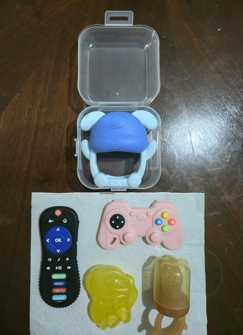 Pacifiers amd Teethers Set (Category: Soothers & Pacifiers) located in Quezon City. Submitted by superrandomthings (Listing ID 1448046060, Image 3). Description: Brands: • Pacifier: Dr. Brown's • Teethers: ◦ Hoshi Baby (Remote Control and Game Controller) ◦ Baby Pro (Blue Rabbit) ◦ Unknown brand (Tweety Bird and Fruit Feeder) Features: Dr. Brown's Pacifier • Almost brand new; only used twice with my baby, who didn't want to use a pacifier. • Desi